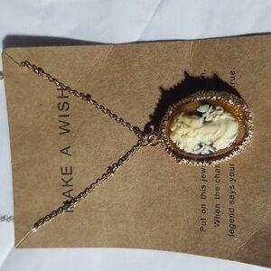 Goldtone costume necklace with adjustable length chain. New.